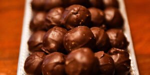 Close-up photo of chocolate truffles on a silver tray