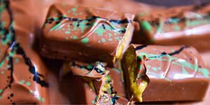 A photograph of several ectangular chocolate bars with green decoration on top