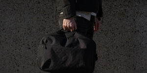 Image of a man holding a backpack.