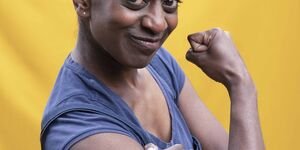 Image of a woman posing in the style of the 'We Can Do It!' poster.