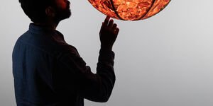 Image of a man in front of a lamp.