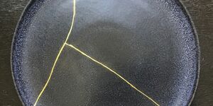 Image of a black ceramic with gold decoration.