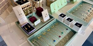 A selection of gold and silver necklaces displayed on a table