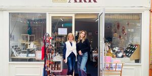 Two women stand outside a shop front