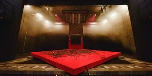 An image of an empty stage with a red square floor.