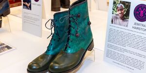 Image of a green pair of boots on display.