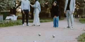 Image of three people playing boules.