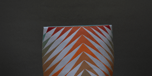 An orange ceramic vase.