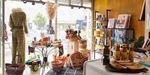 The inside of a shop in which accessories are displayed on a counter and in the window