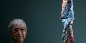 Image of Caroline sitting next to one of her ceramics.