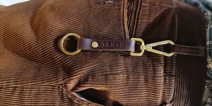 An image of a leather key fob hanging from a belt.