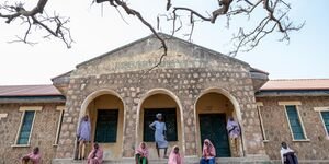 Image of a group of young girls standing outside a church.
