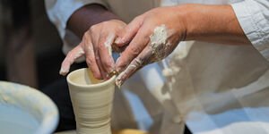 Image of someone making a clay vase.