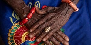 Image of a woman's hands crossed.