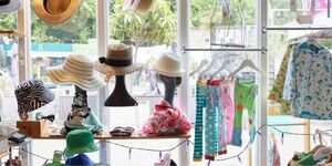 A shop window filled with hats and clothing