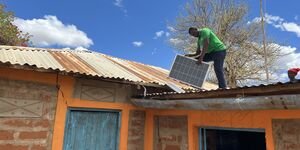 Image of a man installing a solar panel.