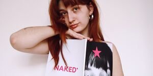 Image of a woman holding a magazine.