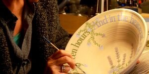 Image of Liz decorating a bowl.