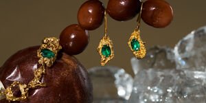 Image of gold and emerald earrings.