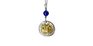 Image of a gold coin necklace with a blue gemstone.