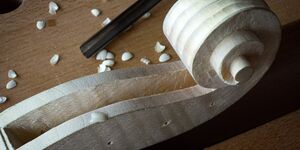 Close up of a carved violin.