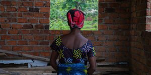 Image of a woman facing a wall.