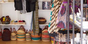 A selection of colourful baskets are displayed inside a shop