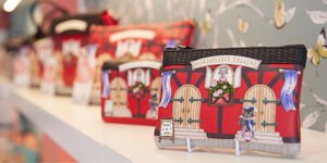A photograph of a selection of leather clutch bags sitting on a white shelf