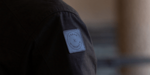 Image of someone wearing a jacket with a logo.
