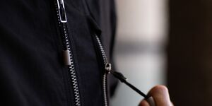 Image of someone wearing a jacket with a zip.