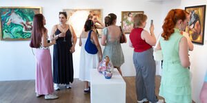 Image of people looking at art in a gallery.