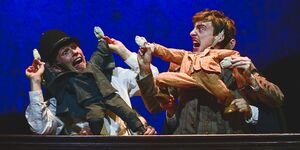 Image of two actors performing on stage.