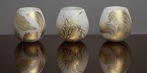 Image of three grey and gold ceramic vases.