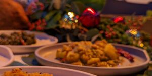 An image of chicken dishes surrounded by Christmas decorations.