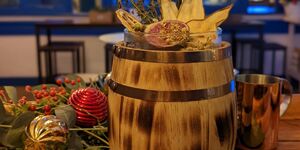 A photo of a Caribbean cocktail surrounded by Christmas decorations.