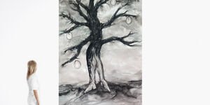 Image of a woman walking past a painting of a tree.