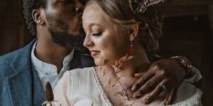 An image of a couple on their wedding day wearing Catherine's jewellery.