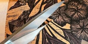 Image of a fabric with a pair of scissors.