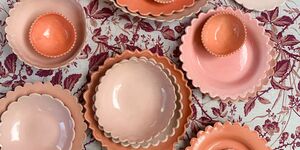 A spread of coral ceramic plates.