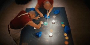 Image of two monks making a mandala.