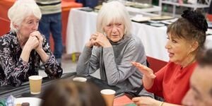 adults chat at a coin street event