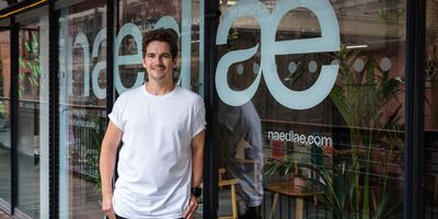 An image of Ricky standing in front of his hairdressing studio.
