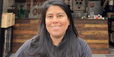 Image of Margarita standing in front of HolaGuacamole.