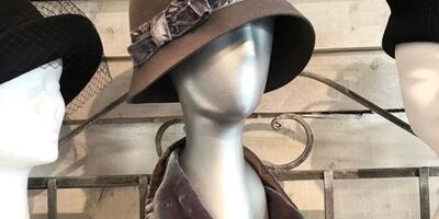 Image of a brown hat modelled on a mannequin.