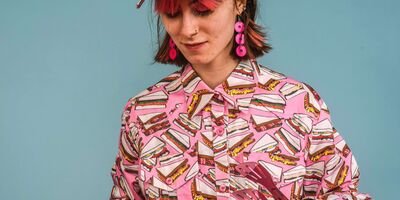 Image of a girl dressed in pink making a sandwich.