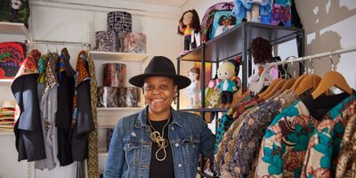 Image of Mariatu standing in her shop.