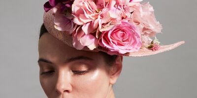 Image of a model wearing Katherine Elizabeth Millinery's pink hat.