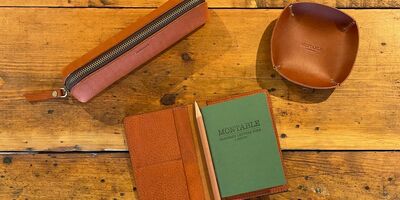 Image of a set of leather goods including a pencil case and a passport cover.