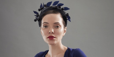 Image of a woman wearing a navy headband.
