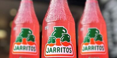 Image of three pink soft drink bottles.